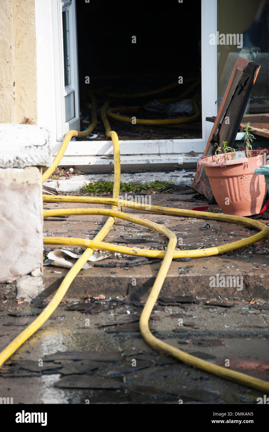 Fire hosereel hose house front door severe gutted Stock Photo
