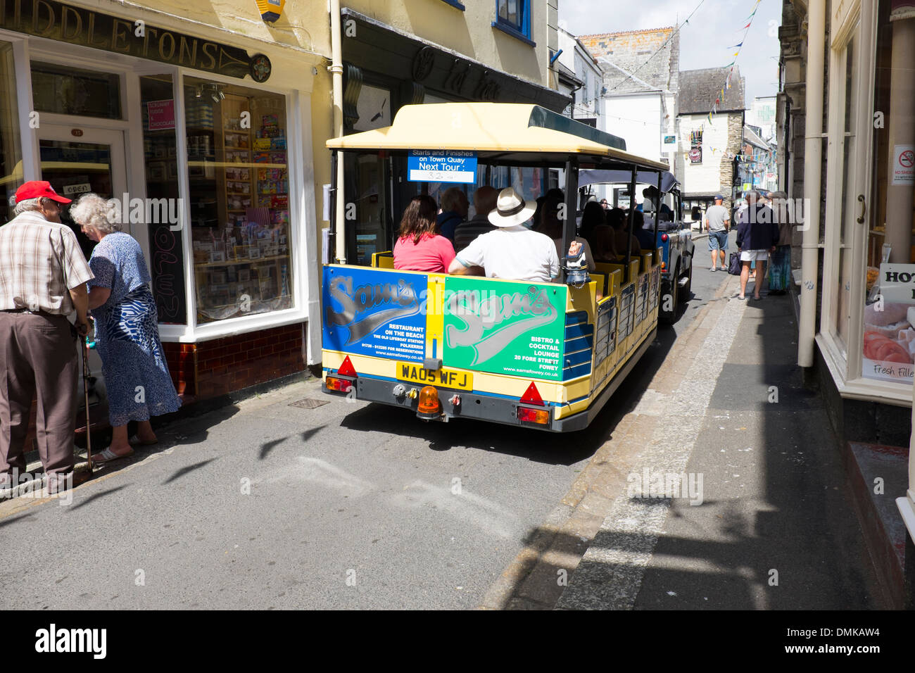 Tourist Road train bus through narrow streets Stock Photo