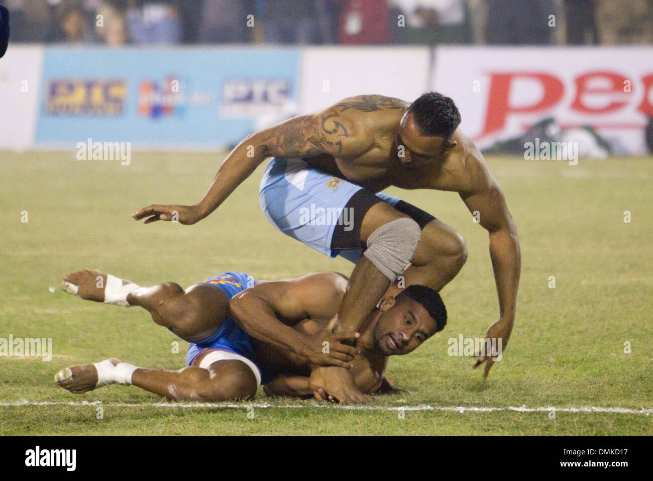 Ludhiana, Punjab of India. 15th Dec, 2013. Players from India (Top) and Pakistan compete at the men's final of the 4th Kabaddi World Cup in Ludhiana, Punjab of India, Dec. 15, 2013. Indian men's team defeated Pakistan by 48-39. Credit:  Javed Dar/Xinhua/Alamy Live News Stock Photo