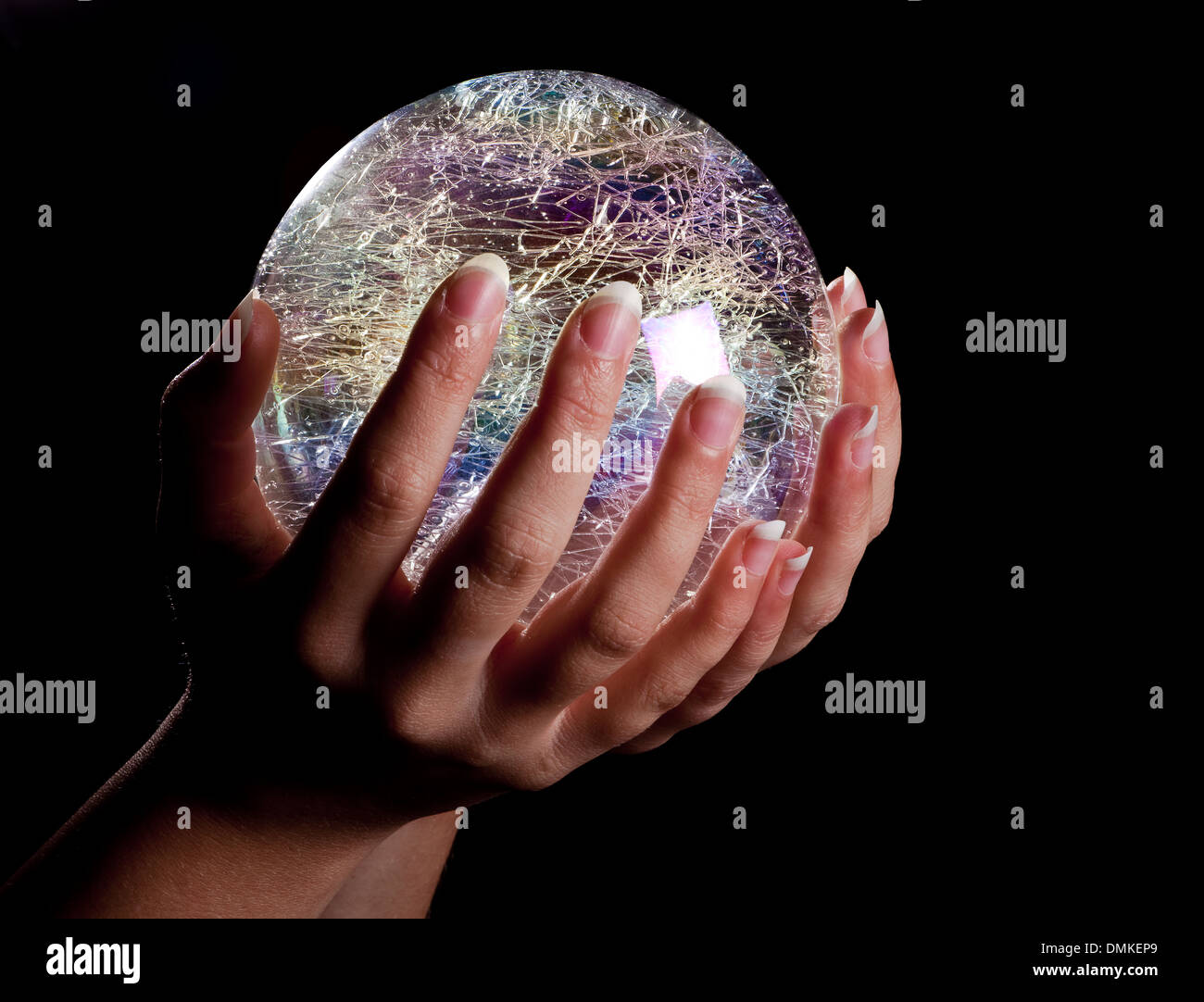 Hands holding a glowing colorful glass or crystal ball Stock Photo - Alamy