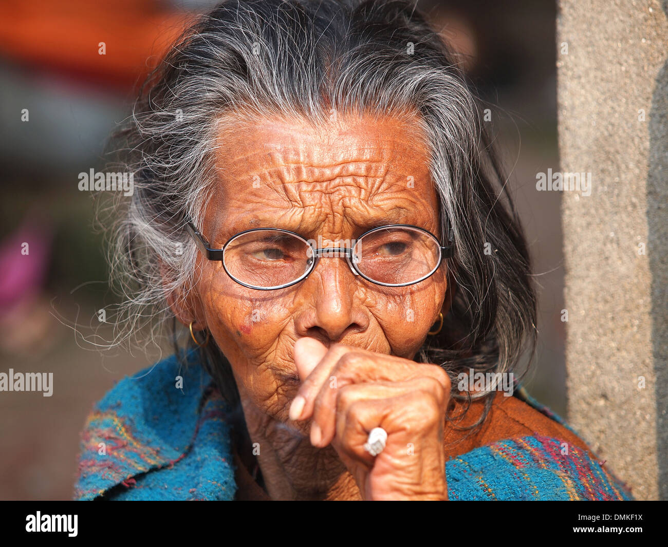 very old woman smoking cigarette Stock Photo