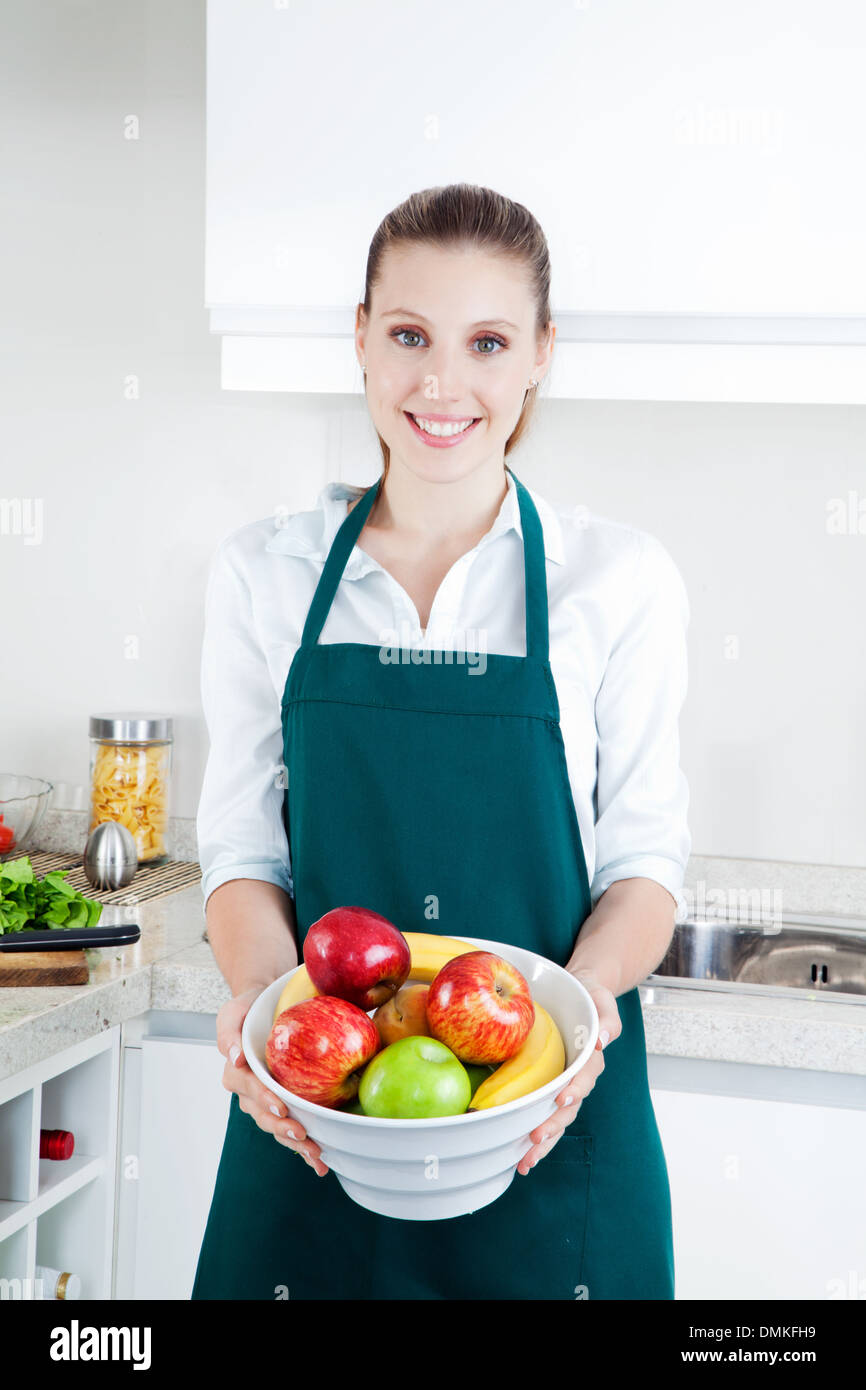 Woman with Fruit in Kitchen Stock Photo Alamy