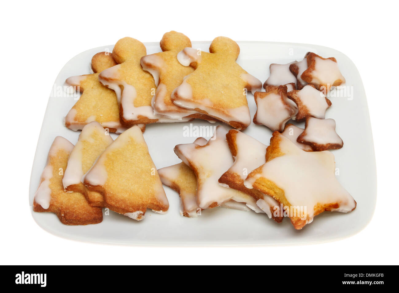 Christmas themed shortbread biscuits on a plate isolated against white Stock Photo