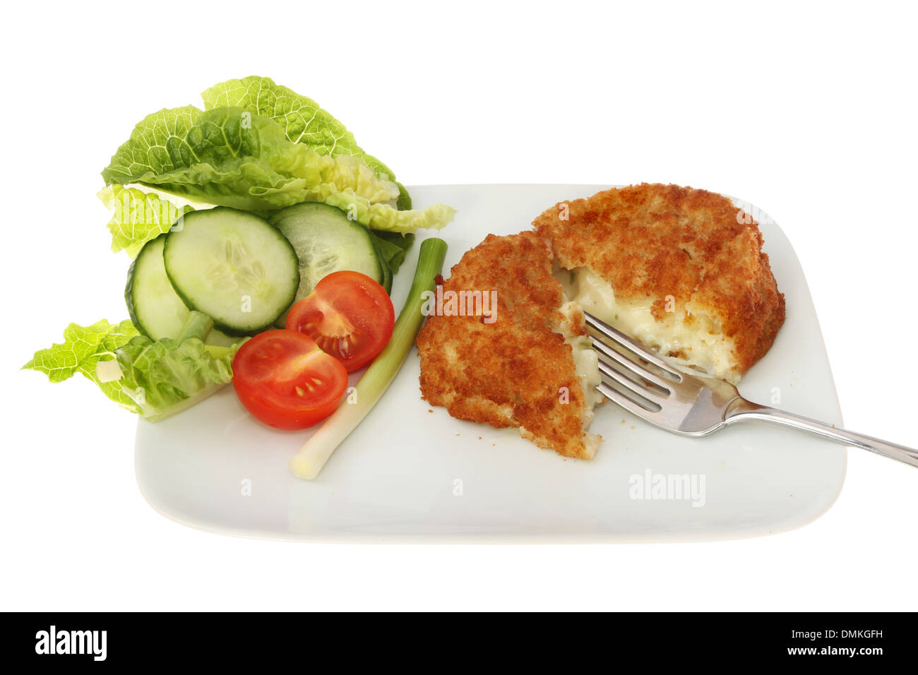 Fish cake and salad with a fork on a plate isolated against white Stock Photo