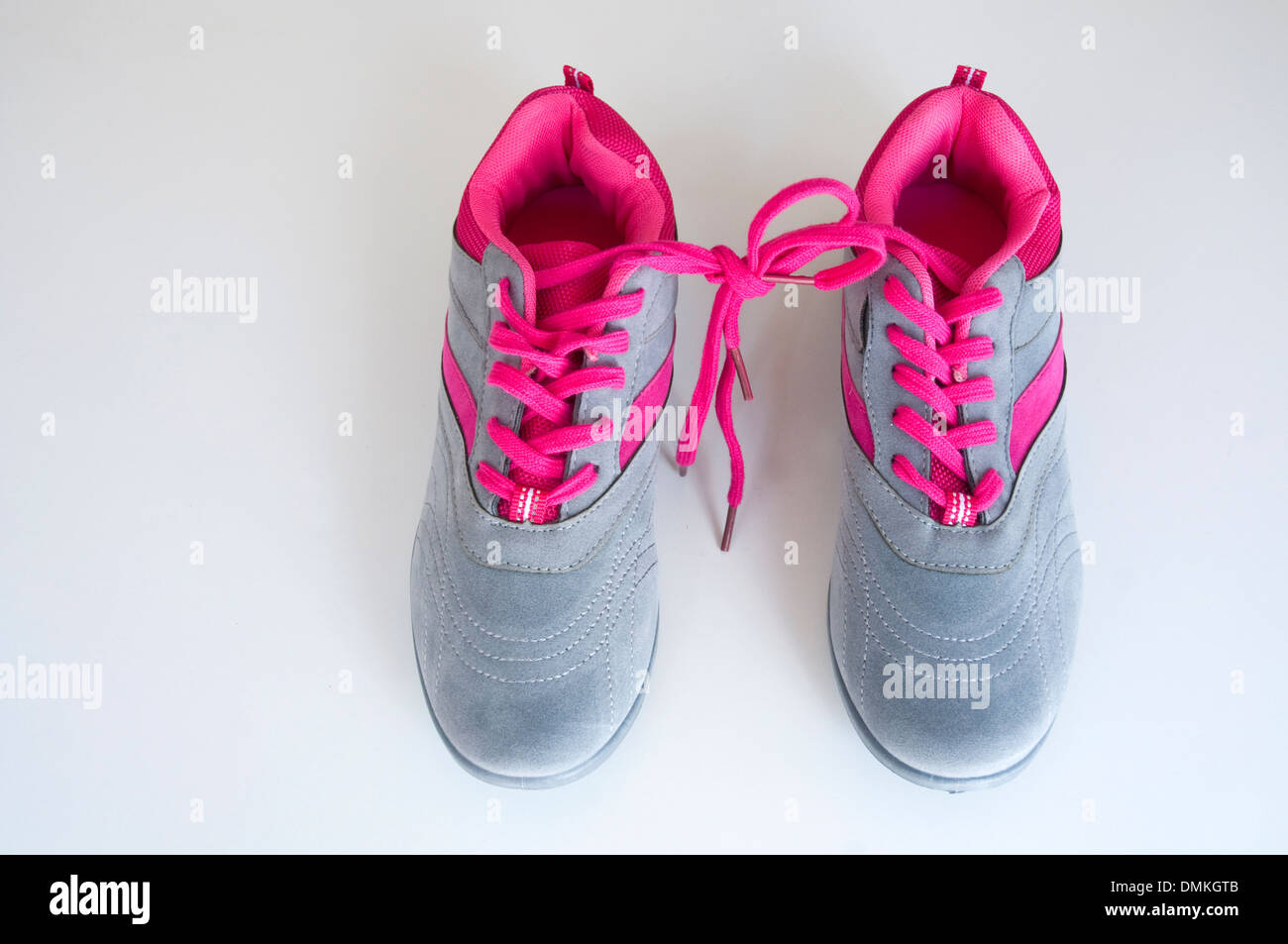 Pair of sneakers with their laces tied each other. Stock Photo