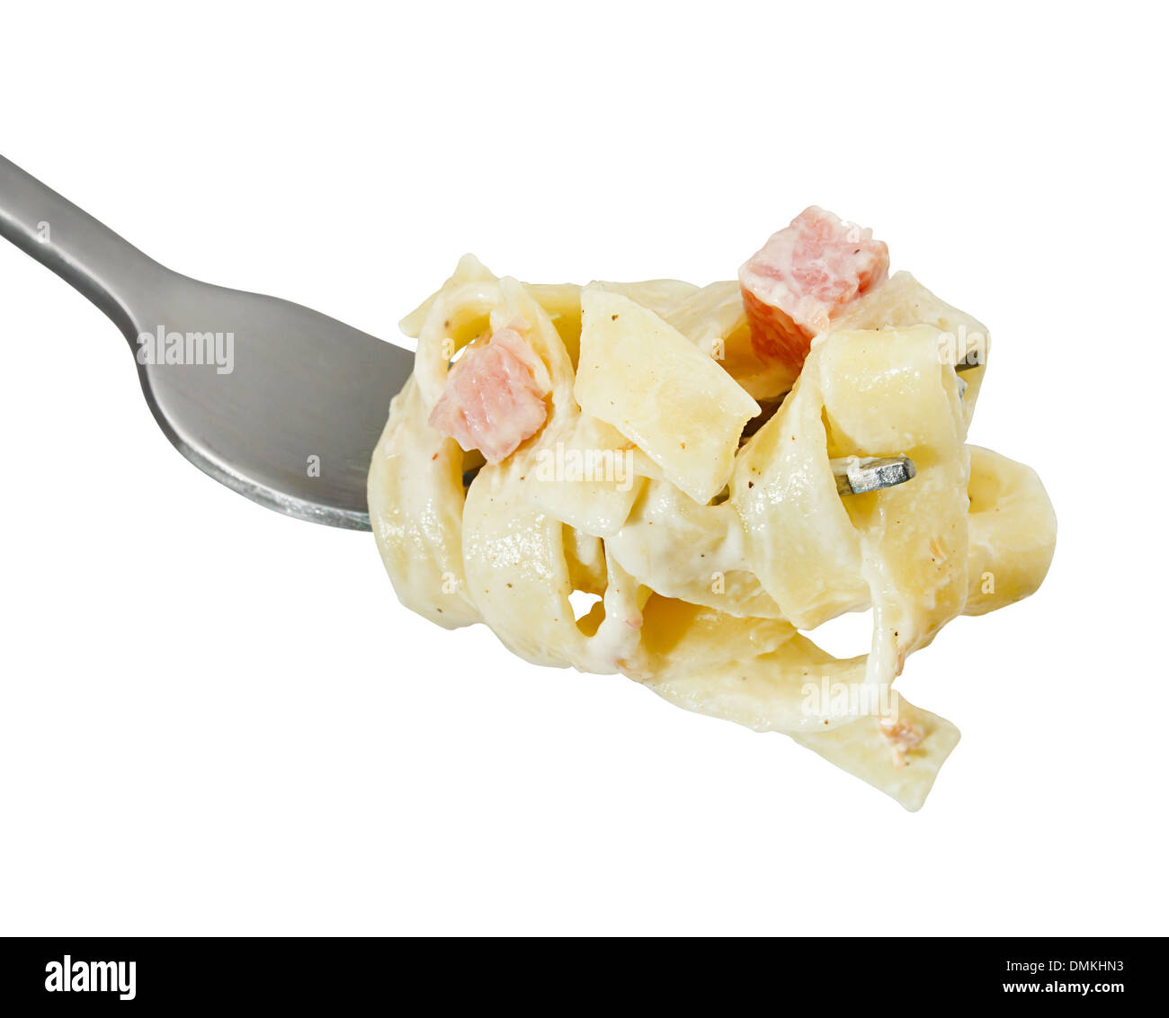 tagliatelli carbanara italian cuisine on a fork, traditionally made from pasta, cream and bacon lardons Stock Photo