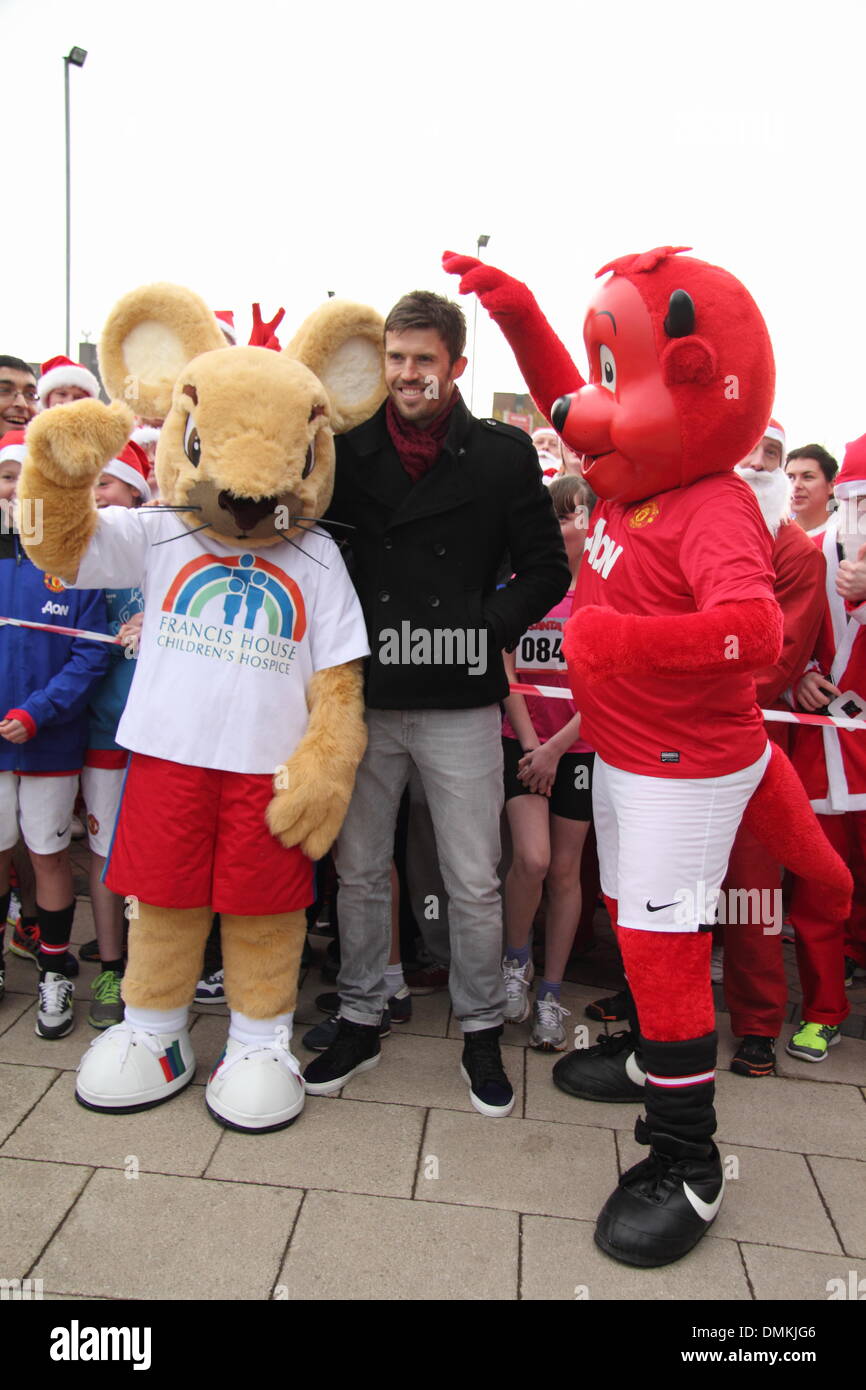 Old Trafford, Manchester, UK. 15th Dec 2013. Manchester United footballer,  Michael Carrick with charity mascots and runners at the seventh annual Manchester  United Foundation Santa Run. The Santa Run is a charity