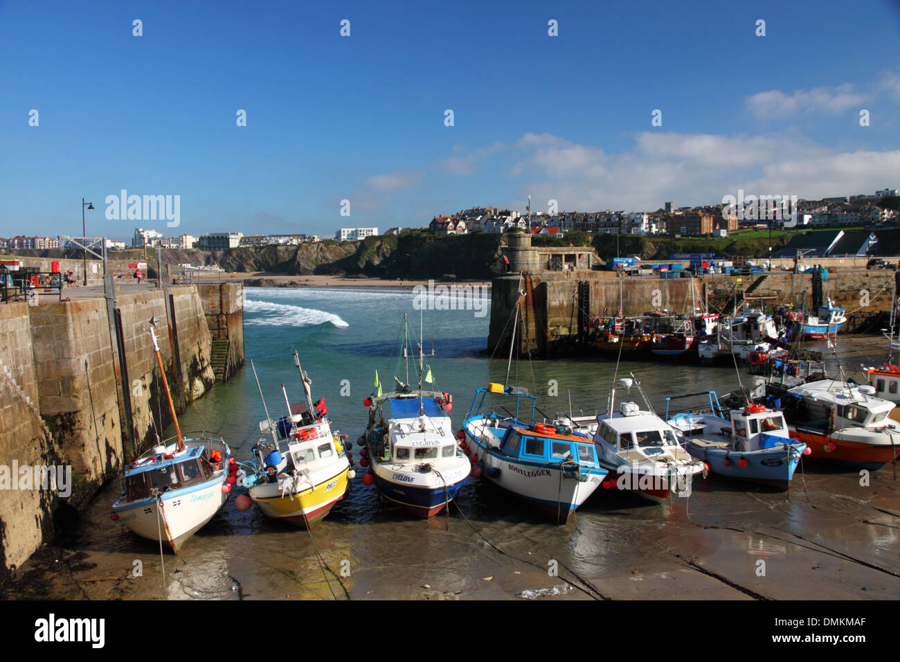 A harbour at low tide with fishing boats, beaches and cliffs Stock ...