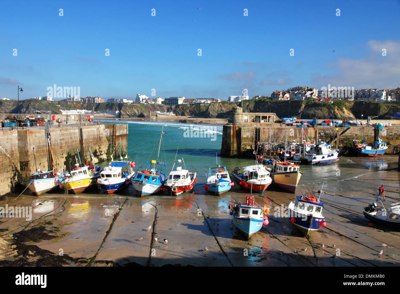 A harbour at low tide with fishing boats, beaches and cliffs Stock ...