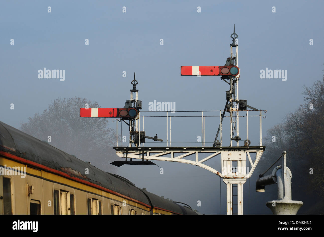 Semaphore signals and winter mist at Horsted Keynes station on the Bluebell Railway, Sussex, England, UK Stock Photo