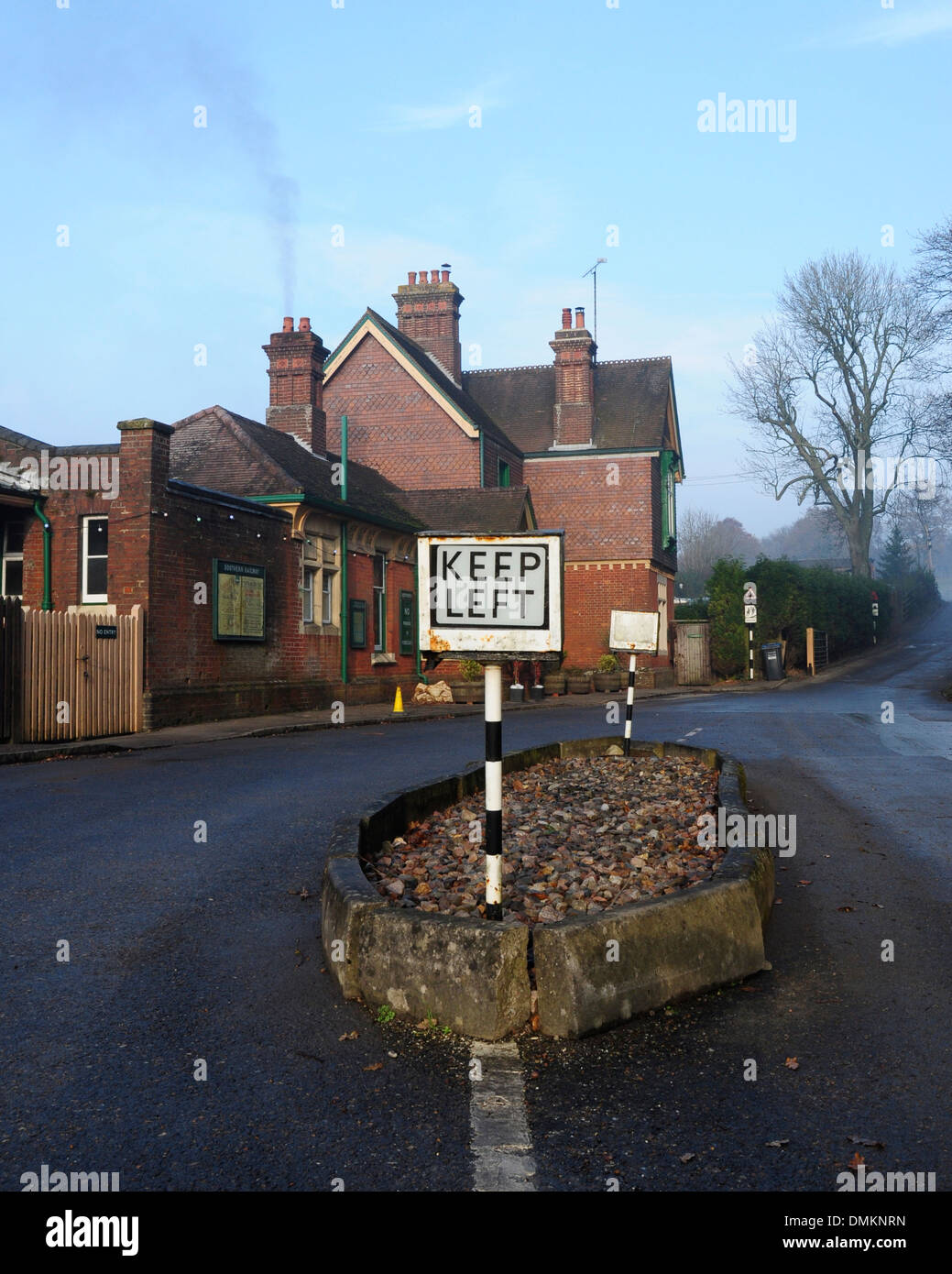 Old style 'keep left' road sign outside Horsted Keynes railway station, Sussex, England, UK Stock Photo