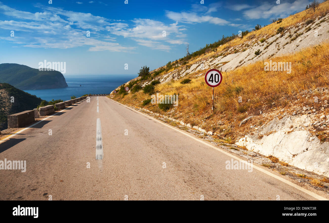 Dividing line and speed limit sign on the mountain highway Stock Photo