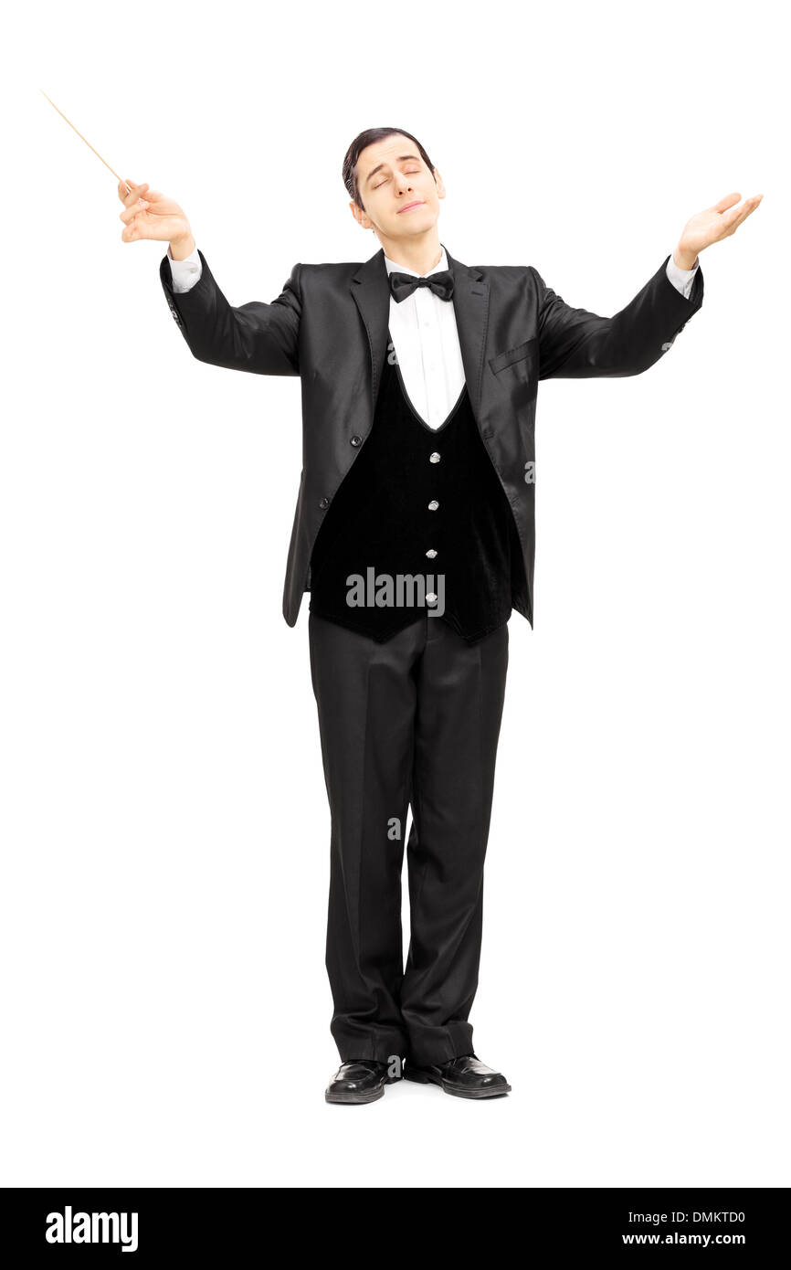 Full length portrait of a male orchestra conductor directing with baton Stock Photo