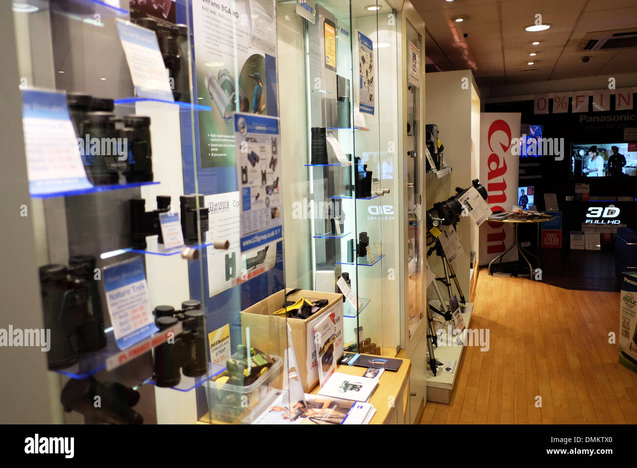 Camera Binocular display cabinet in shop new cameras for sale in glass case lens lenses displayed Stock Photo