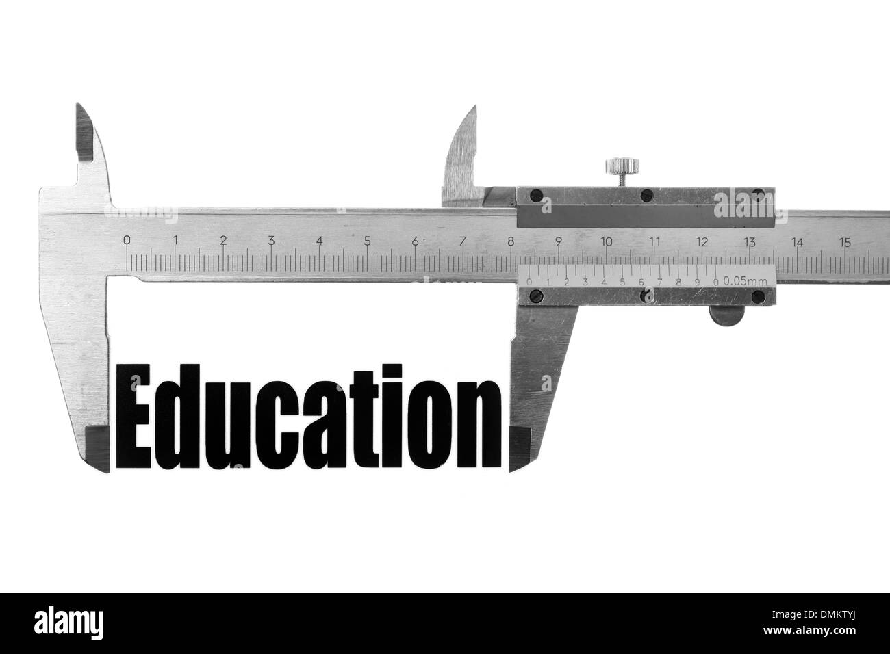 Picture of a caliper measuring the word 'Education'. Stock Photo