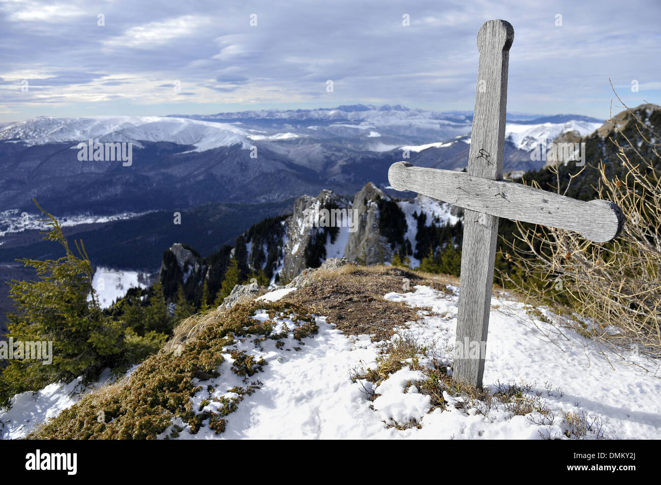 Wooden cross on mountain top in winter Stock Photo