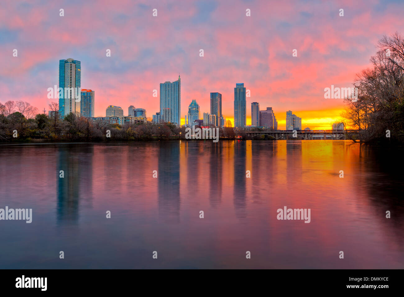 The Austin skyline is reflected in the waters of Lady Bird Lake on an early morning sunrise. Stock Photo