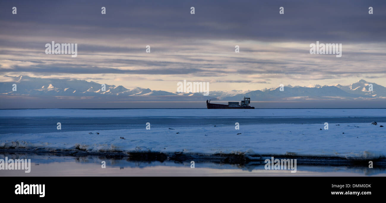 Panorama of gray clouds with abandoned whaling ship on Barter Island Kaktovik Lagoon Alaska USA with Brooks Range mountains Beaufort Sea Arctic ocean Stock Photo