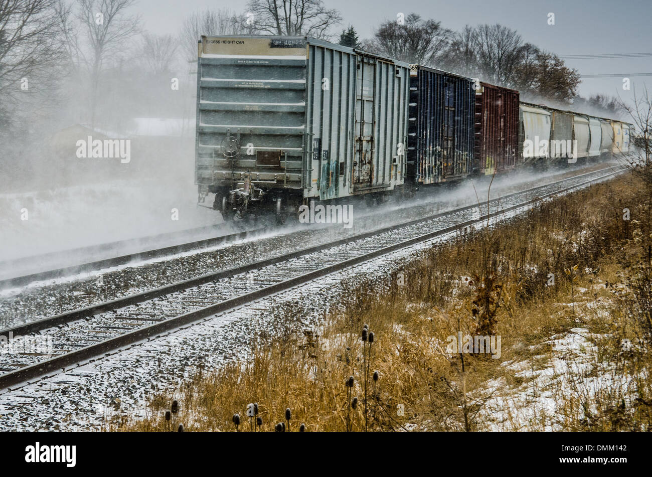 A moving train with blowing snow. Stock Photo
