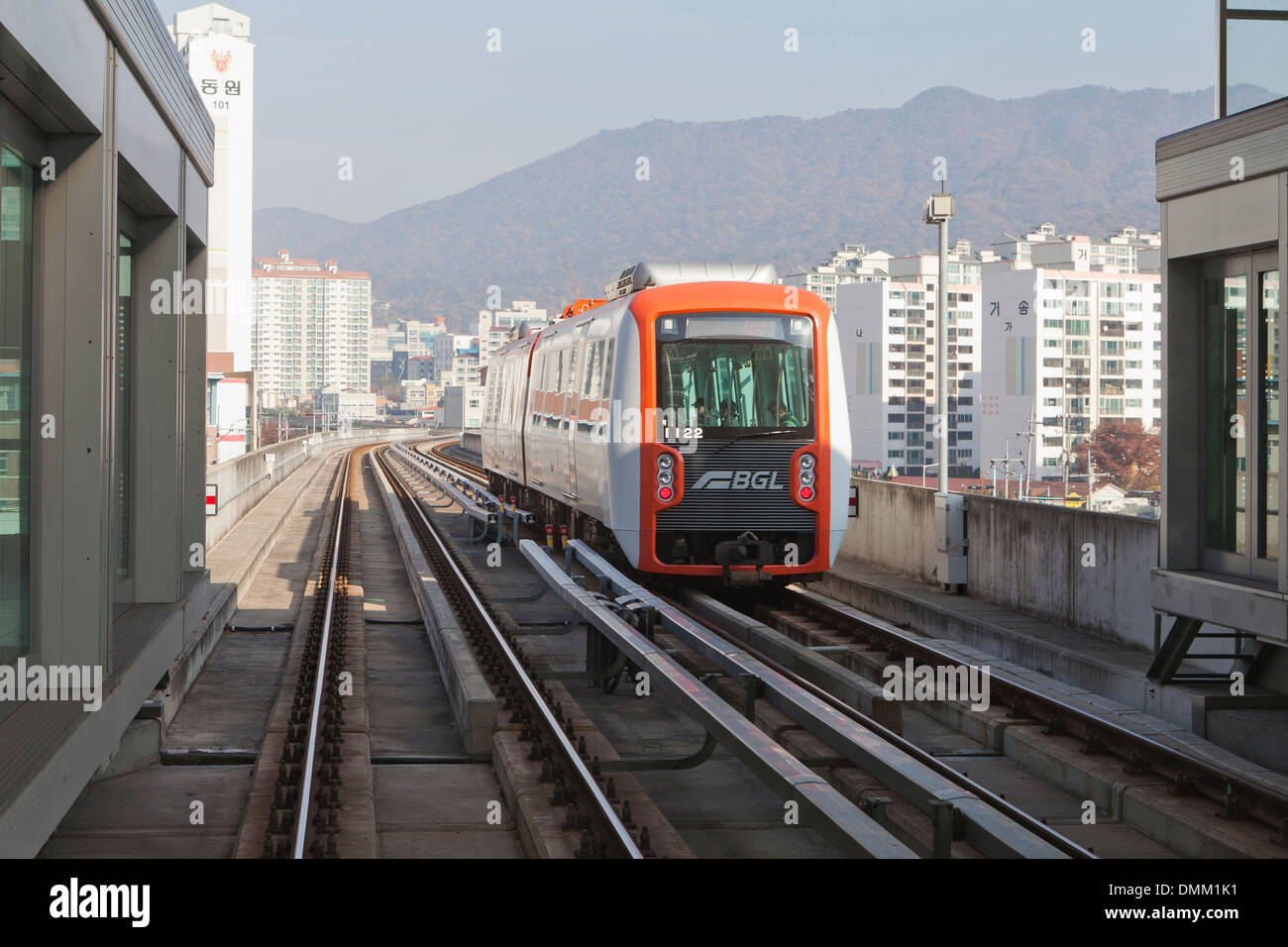 Busan–Gimhae Light Rail Transit train pulling into station - South Korea Stock Photo
