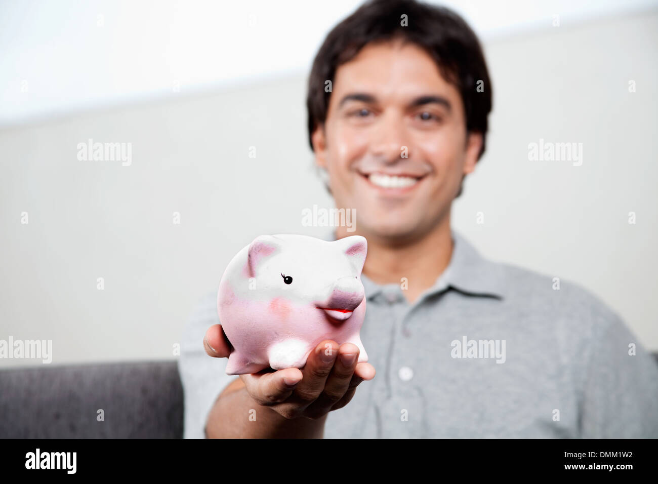 Man Holding Piggy Bank Stock Photo - Alamy