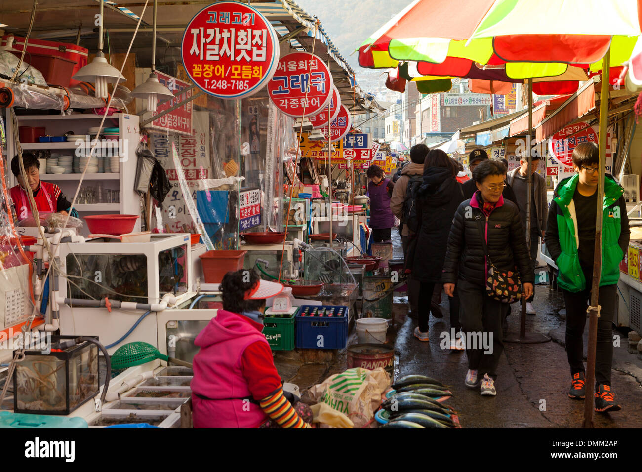 Vendors and shoppers at Jagalchi shijang (traditional outdoor market) - Busan, South Korea Stock Photo