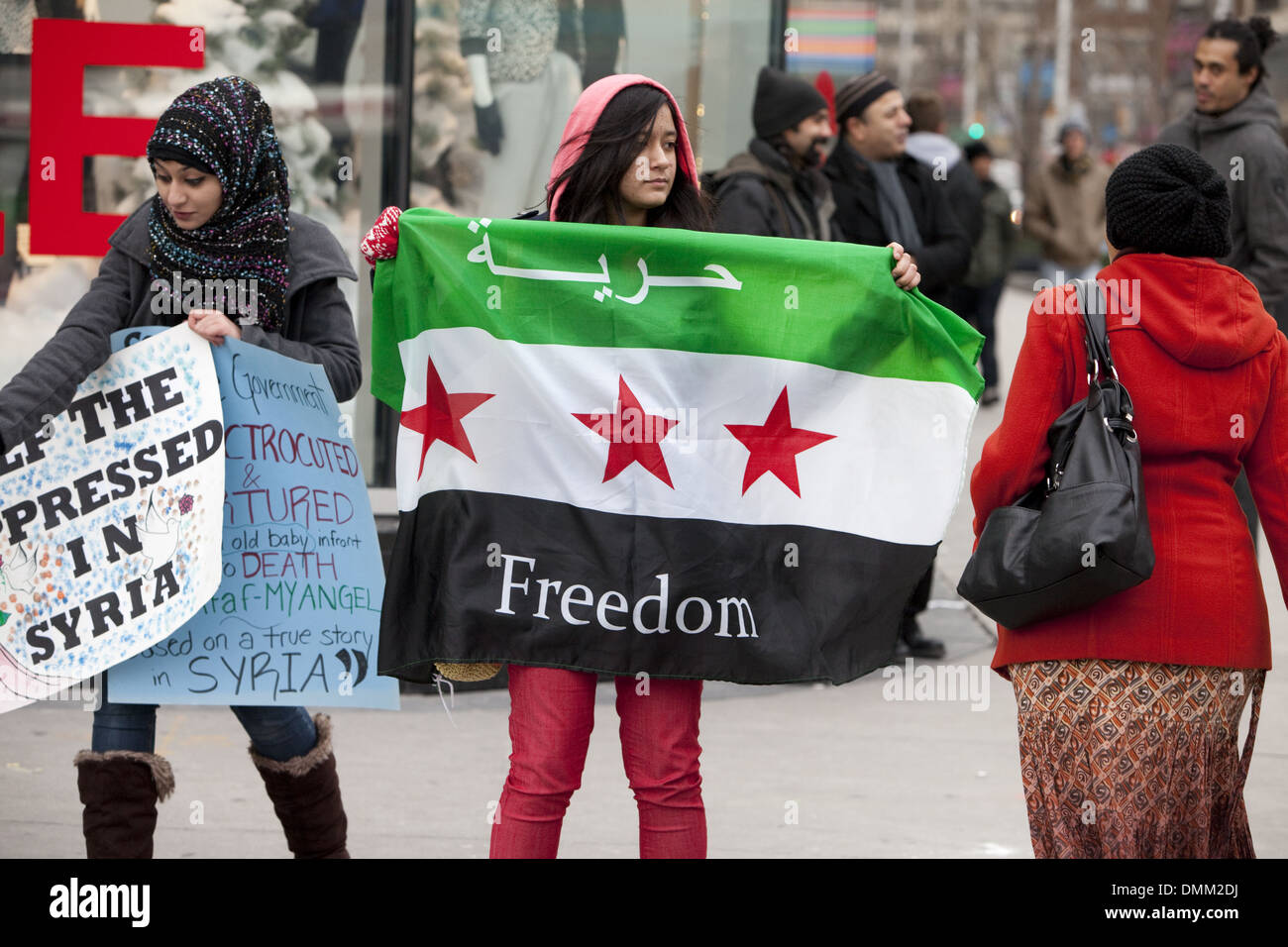 Activists in Toront Canada , holding a Syrian flag demanding freedom to Syria. December 24, 2013 Stock Photo