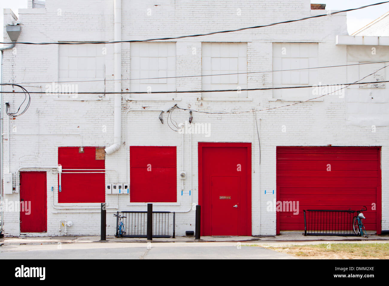 Red doors and windows in the back of a white building in Columbus, Ohio, USA. Stock Photo