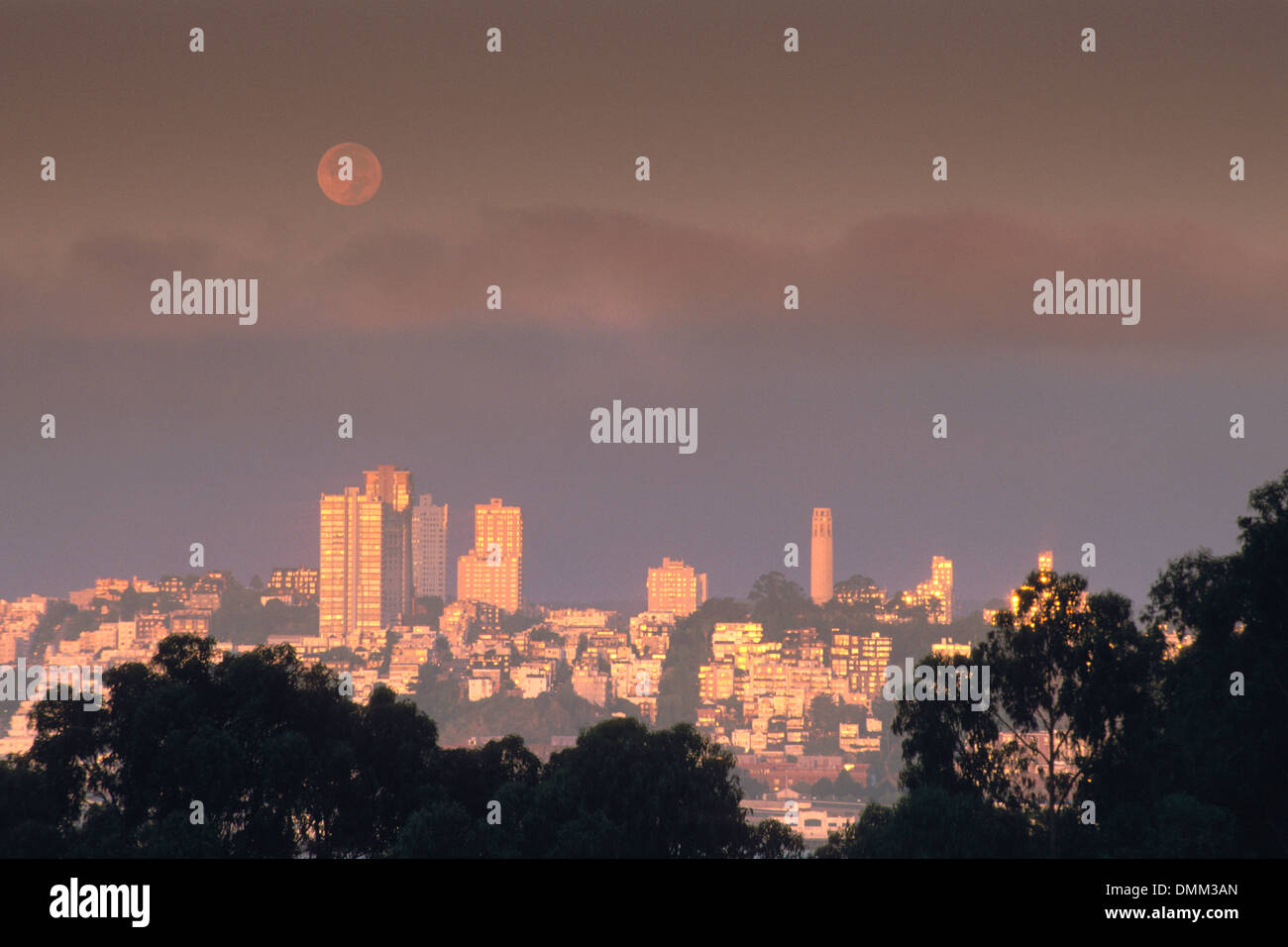 Moonset at sunrise over Coit Tower & Russian Hill, San Francisco, California Stock Photo