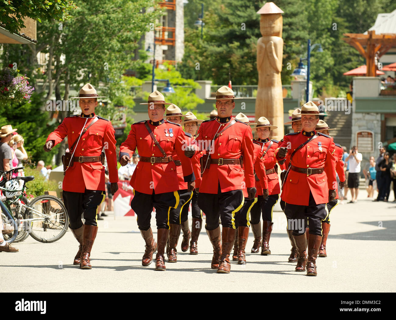 Royal Canadian Mounted Police officers in formal red serge uniforms parade through Whistler BC, Canada Stock Photo