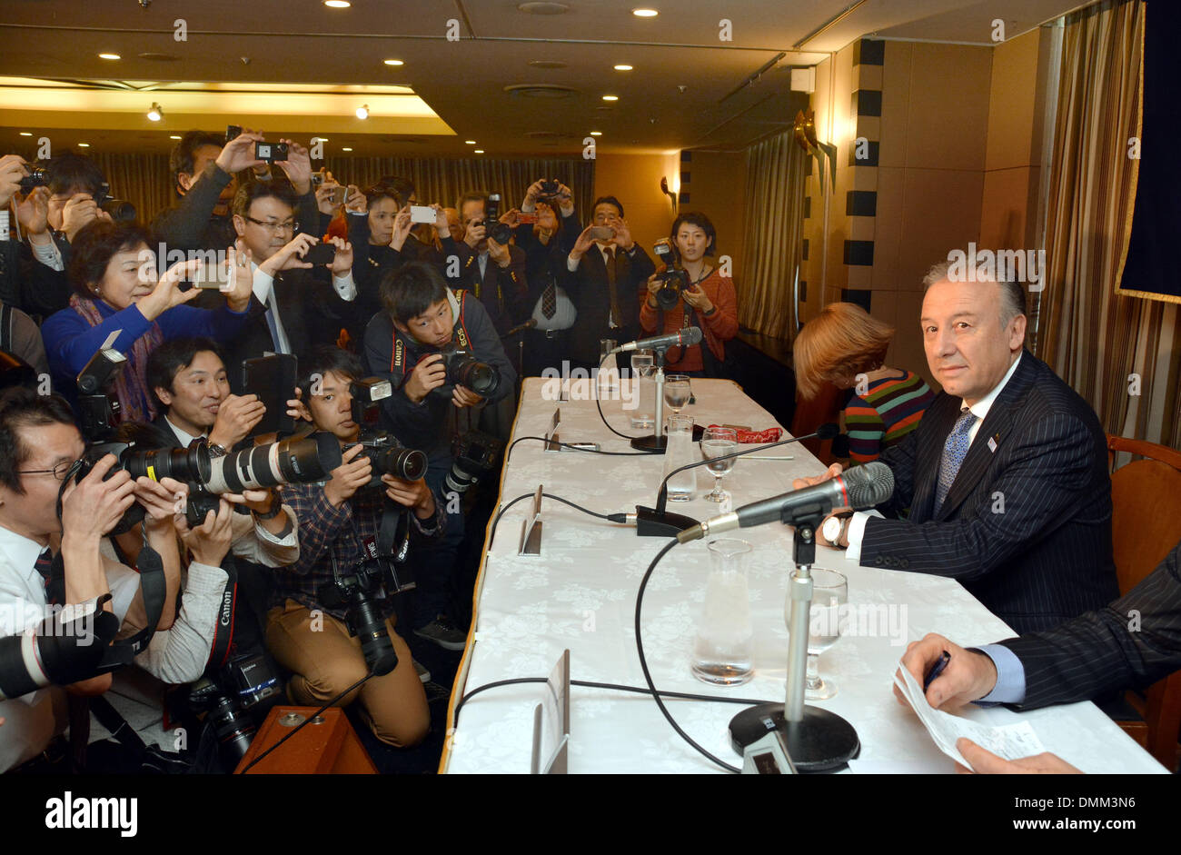 Tokyo, Japan. 16th Dec, 2013. Alberto Zaccheroni, right, the Italian head coach of japan's national football team, faces a battery of photographers at the start of a news conference at Tokyo's Foreign Correspondents' Club of Japan on Monday, December 16, 2013. Zaccheroni and his 11 in the Samurai Blue will meet Ivory Coast, Colombia and Greece in the 2014 FIFA World Cup elimination round slated for June in Brazil. Credit:  Natsuki Sakai/AFLO/Alamy Live News Stock Photo