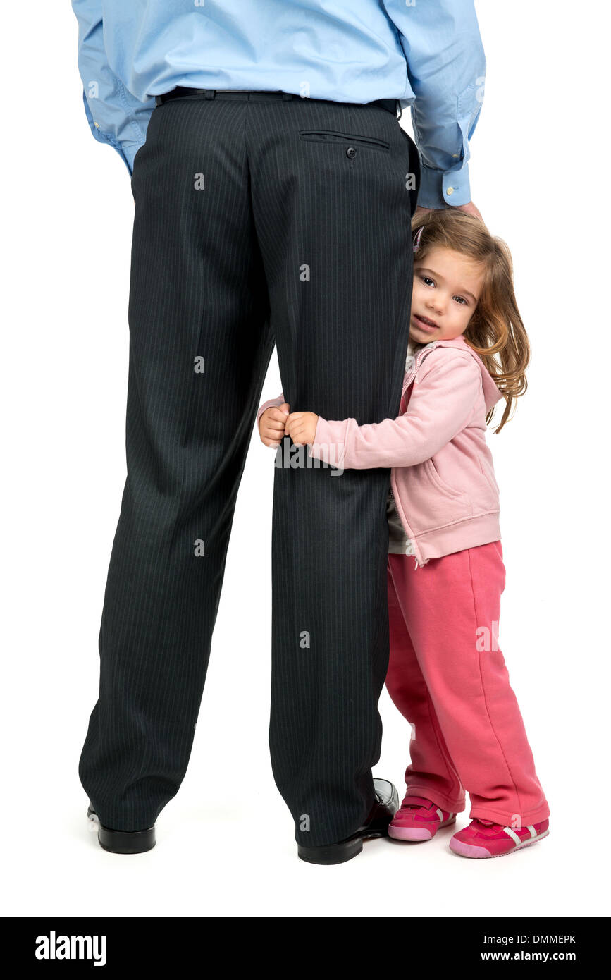 Young girl hugging her father's leg Stock Photo