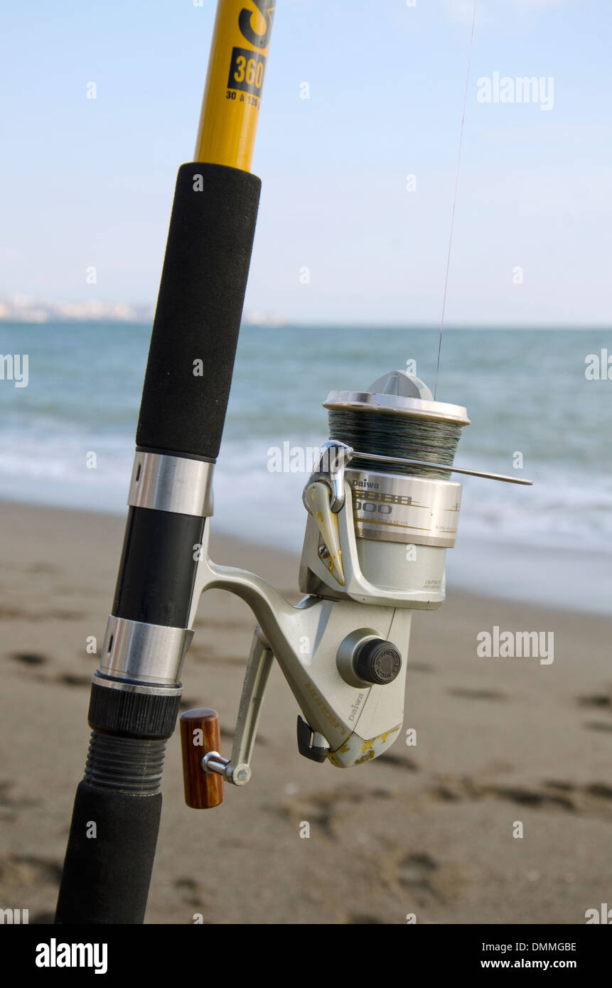 Detail of a fishing reel and rod with mediterranean sea in background.  Malaga, Spain Stock Photo - Alamy