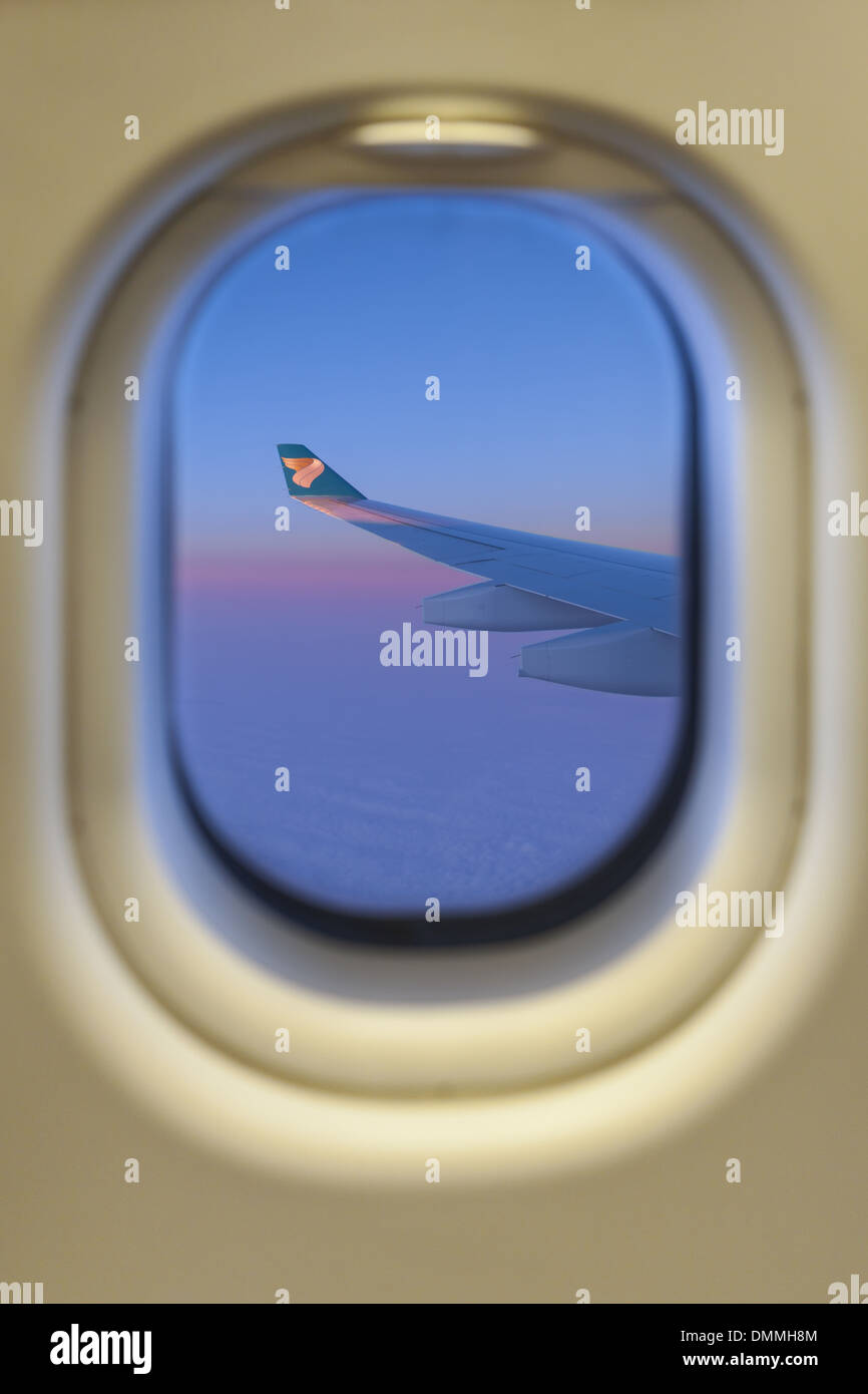 View of airplane wing through window Stock Photo