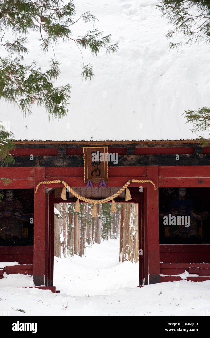 The Zuishinmon Gate at the inner (Oku) Togakushui Shrine, red against the white snow. Stock Photo