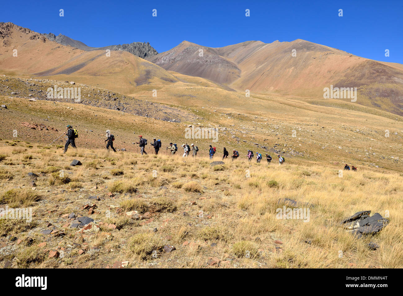 Iran, group of people hiking on Hezar Som plateau, Alam Kuh area, Alborz mountains Stock Photo