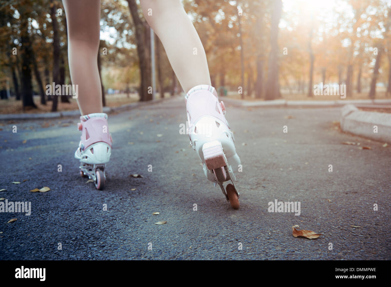Legs of teenager having roller skate exercise in public park Stock Photo