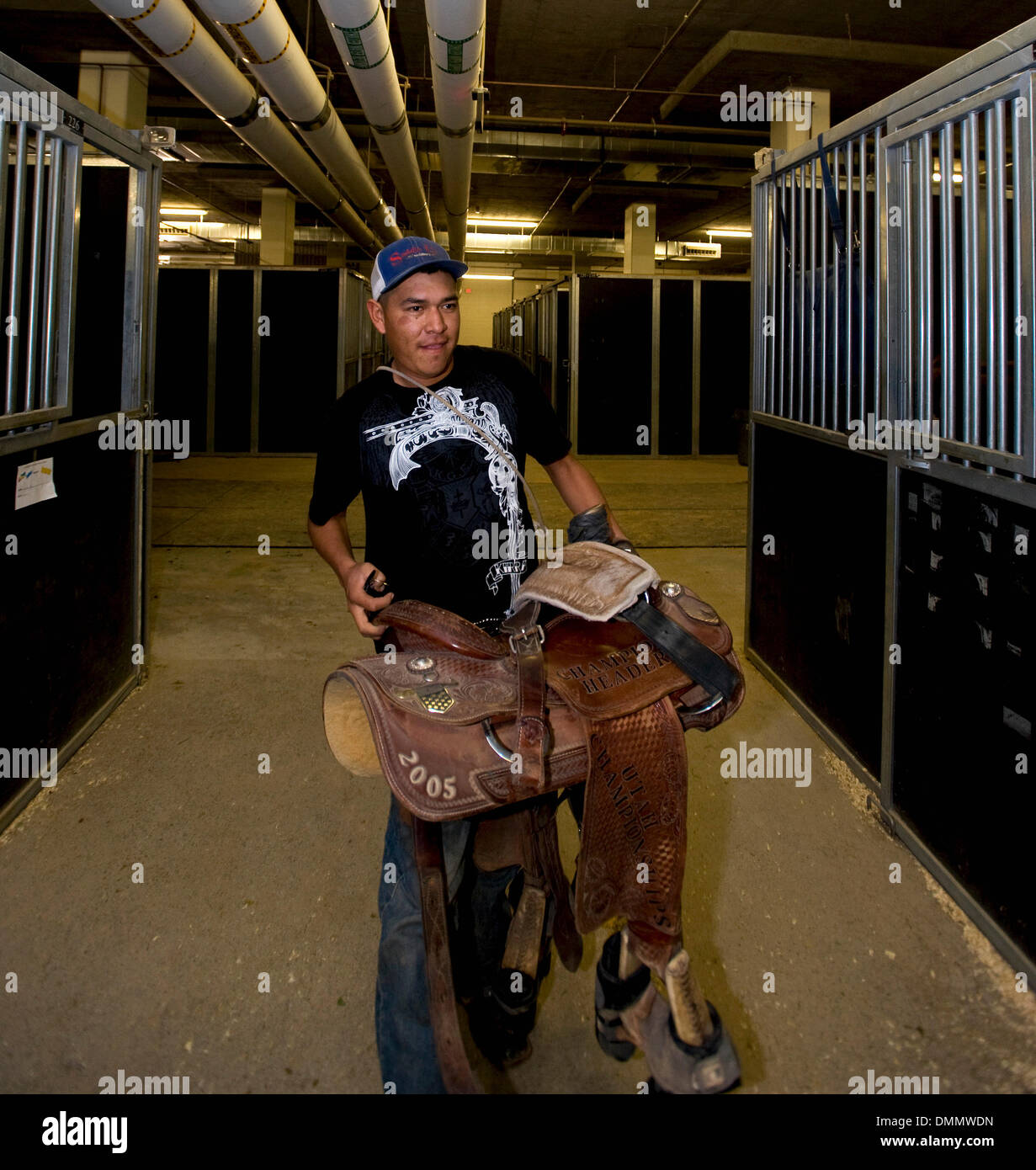 Nov. 10, 2009 - Las Vegas, Nevada, USA -  Calf roper BROOKS DAHOZY humps in his saddle to his assigned stall at the South Point Equestrian Center at the Indian National Finals Rodeo.  The INFR is the culmination of the rodeo year for the 350 Native American and Canadian contestants who qualified in regional and tour events to compete for championship titles in bareback riding, sadd Stock Photo