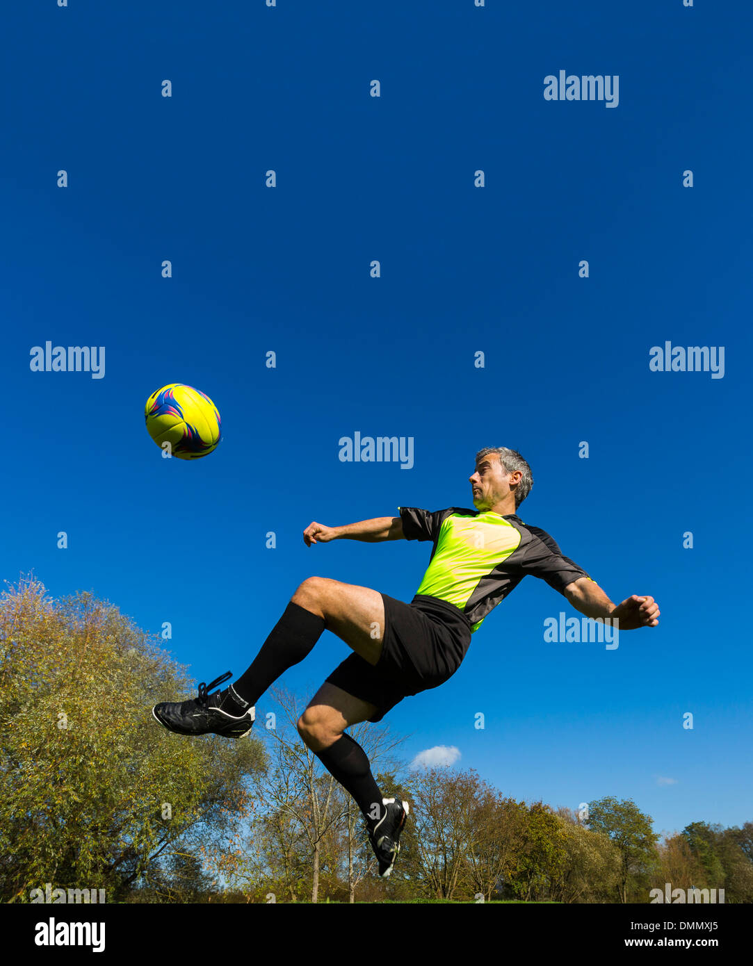 Soccer player kicking ball Stock Photo Alamy