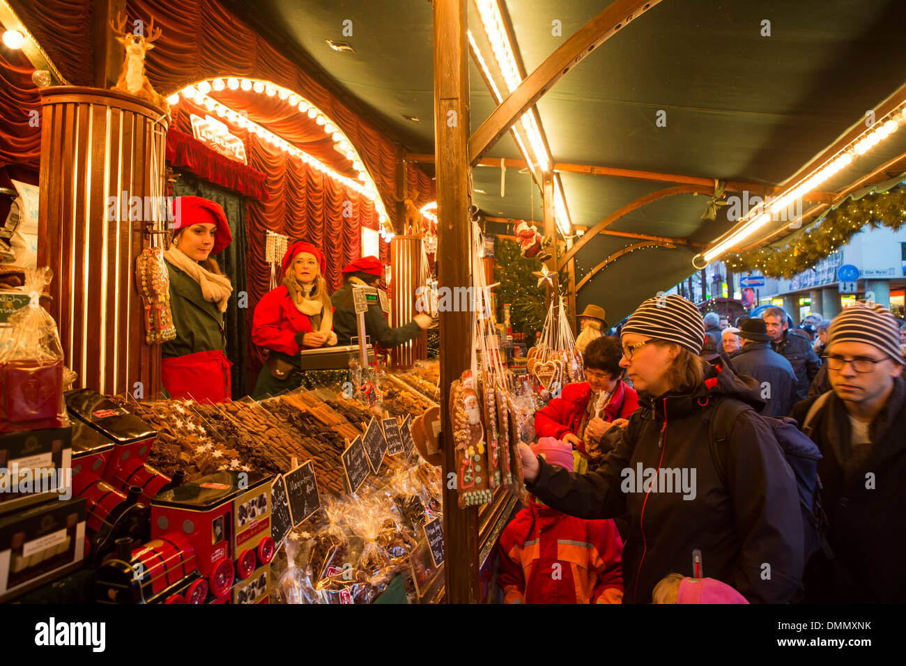 People buying chocolate and cookies at the Christmas Market of Cologne (Altstadt or older part of the city) Stock Photo