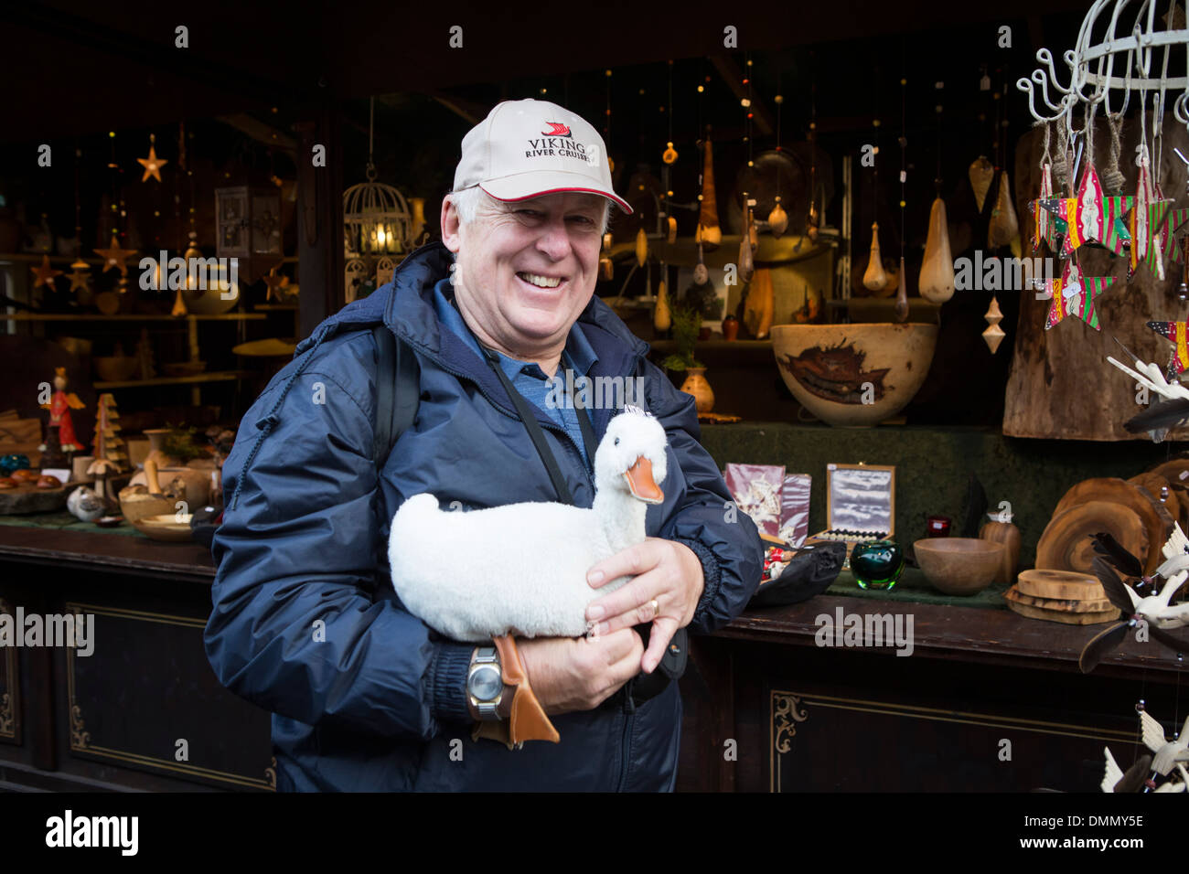 Christmas Market at Cologne, American tourist having bought a toy duck Stock Photo