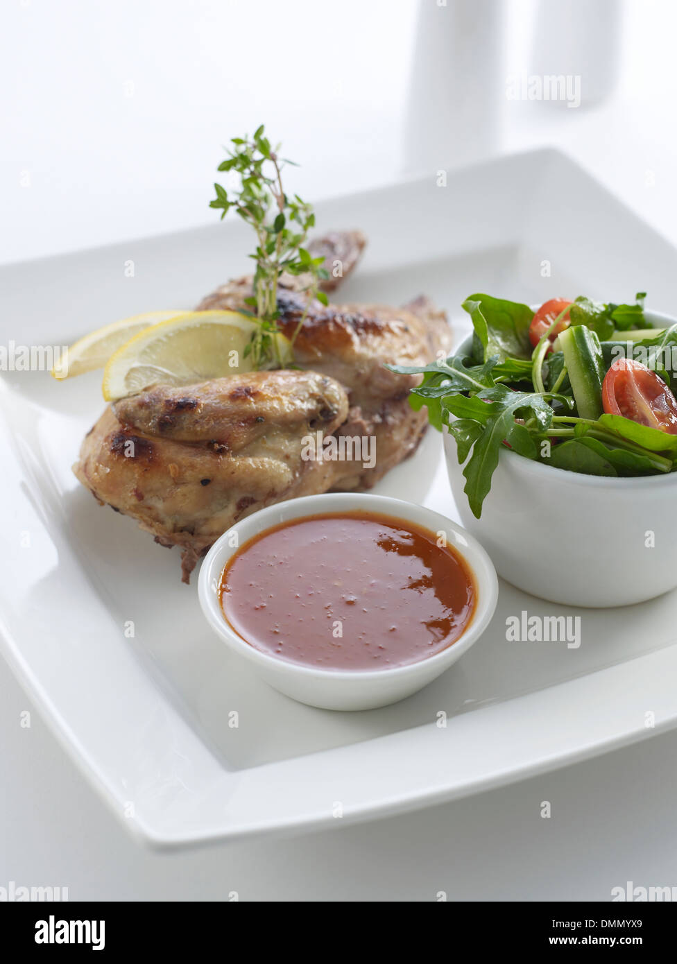 Roast Half chicken with thyme tomato sauce and salad Stock Photo Alamy