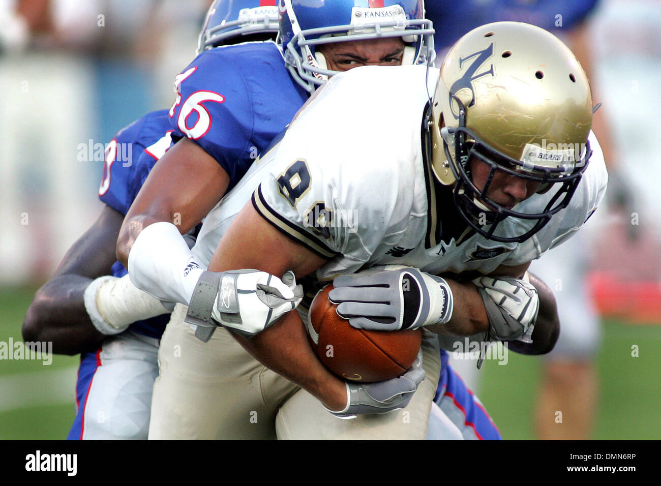 4 September 2009:   Northern Colorado tight end Andrew Emmerling (89) is brought down by Kansas cornerback Justin Thornton (46) and Kansas defensive end Maxwell Onyegbule (90) during game action in the first half. The Kansas Jayhawks defeated the Northern Colorado Bears 49-3 at Memorial Stadium. (Credit Image: © Southcreek Global/ZUMApress.com) Stock Photo