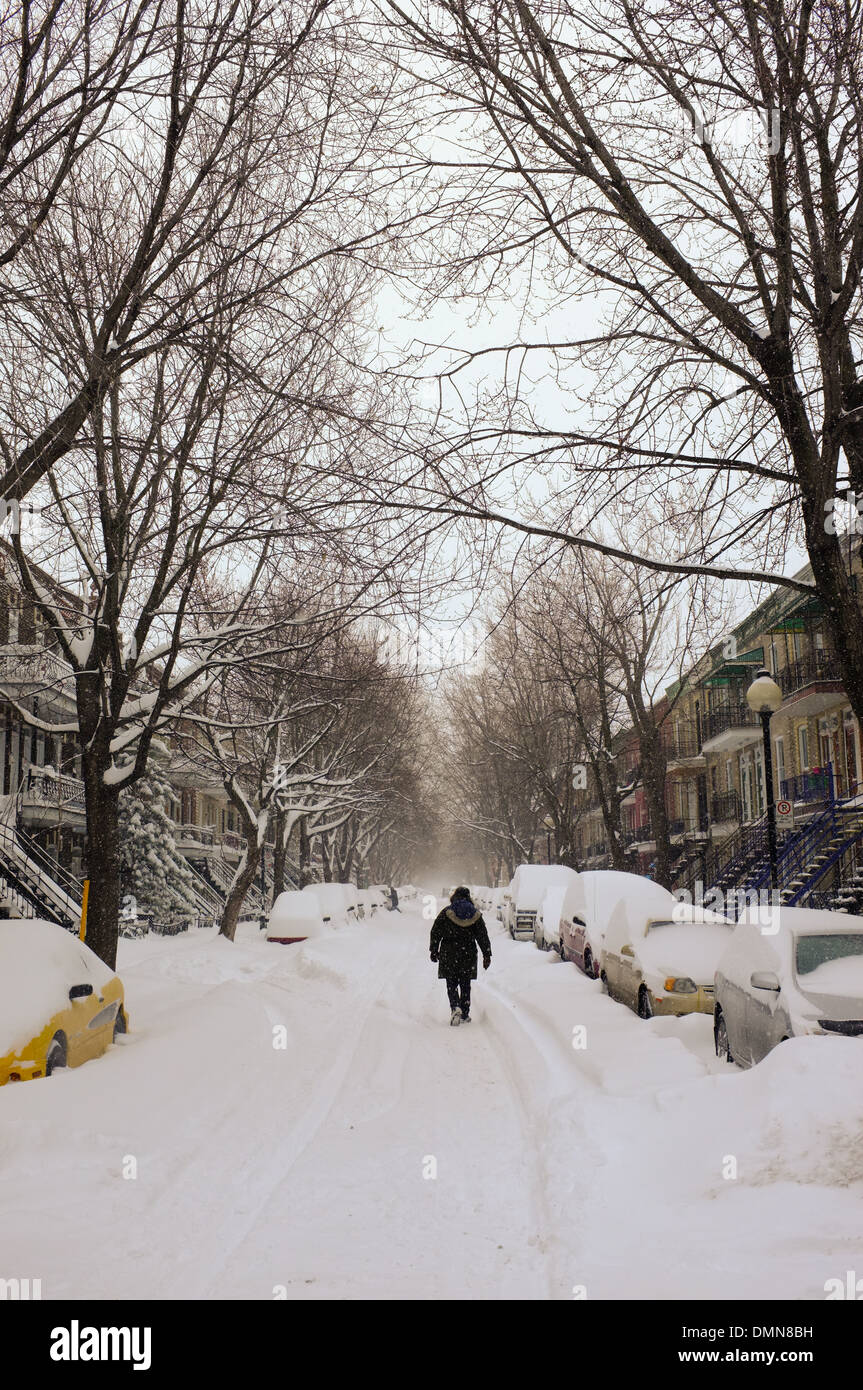 A Person Walking Down A Snow Covered Street In The Plateau Of Stock Photo Alamy
