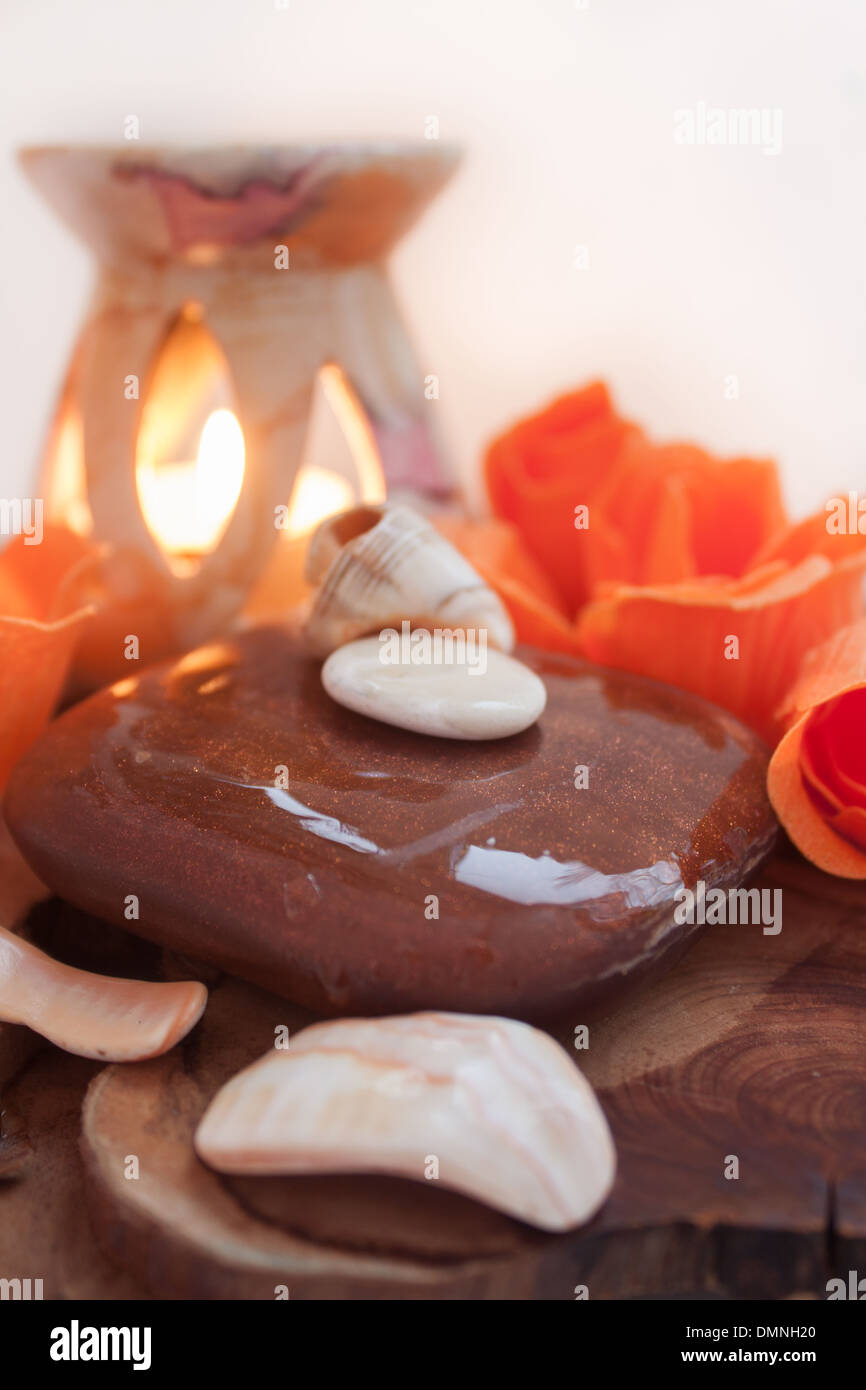 [orange color] [warm colors] spa therapy aromatherapy soap candle 'candle flame 'sea shells' Stock Photo