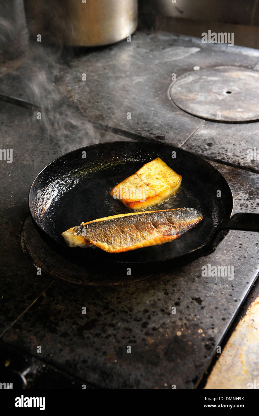 Fish cooking in a pan Stock Photo - Alamy