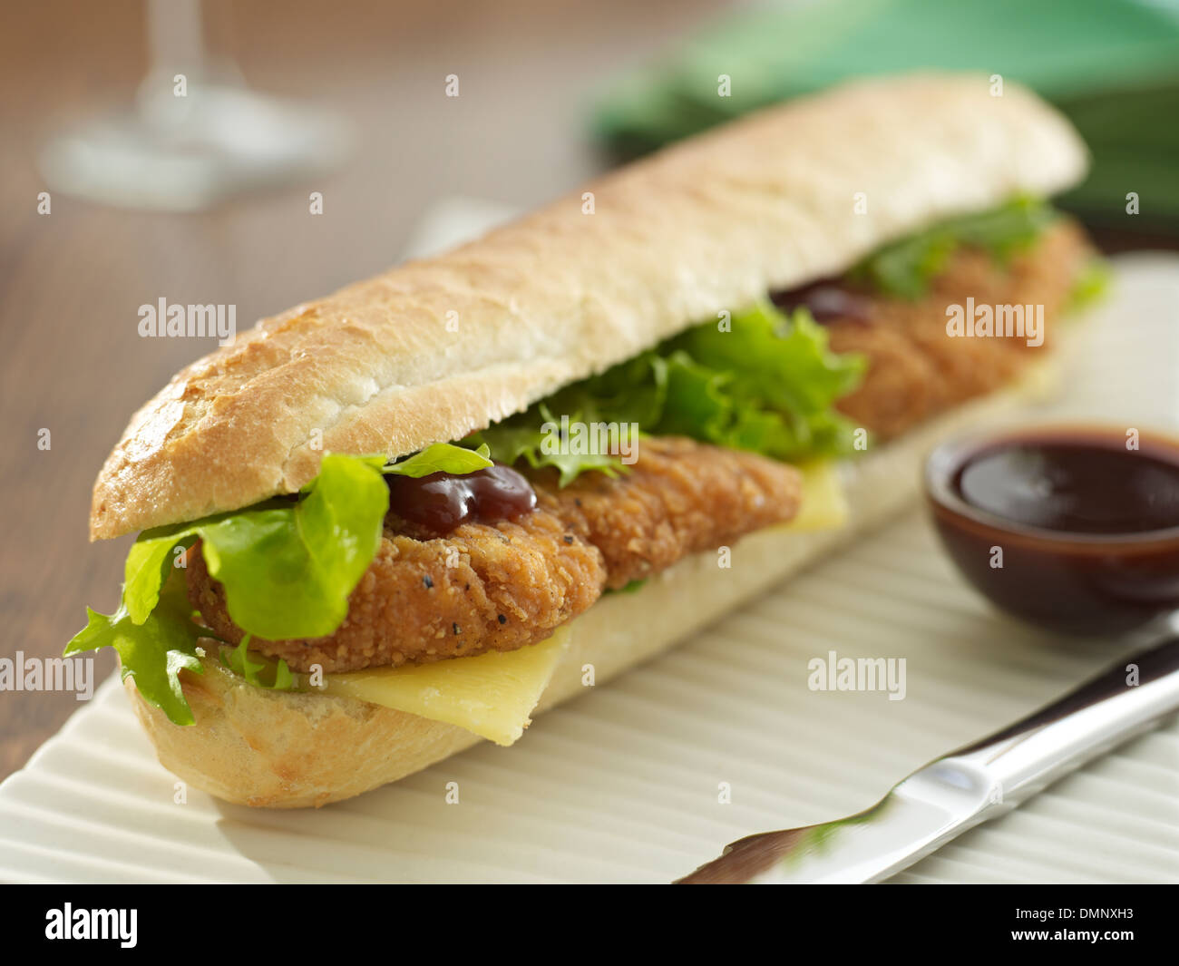 battered chicken salad cheese baguette brown sauce Stock Photo