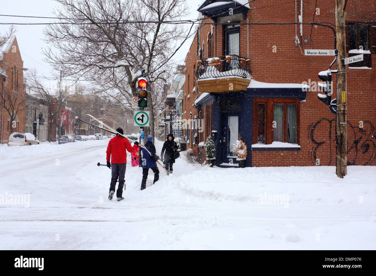 People walking through downtown Montreal with their cross country skis