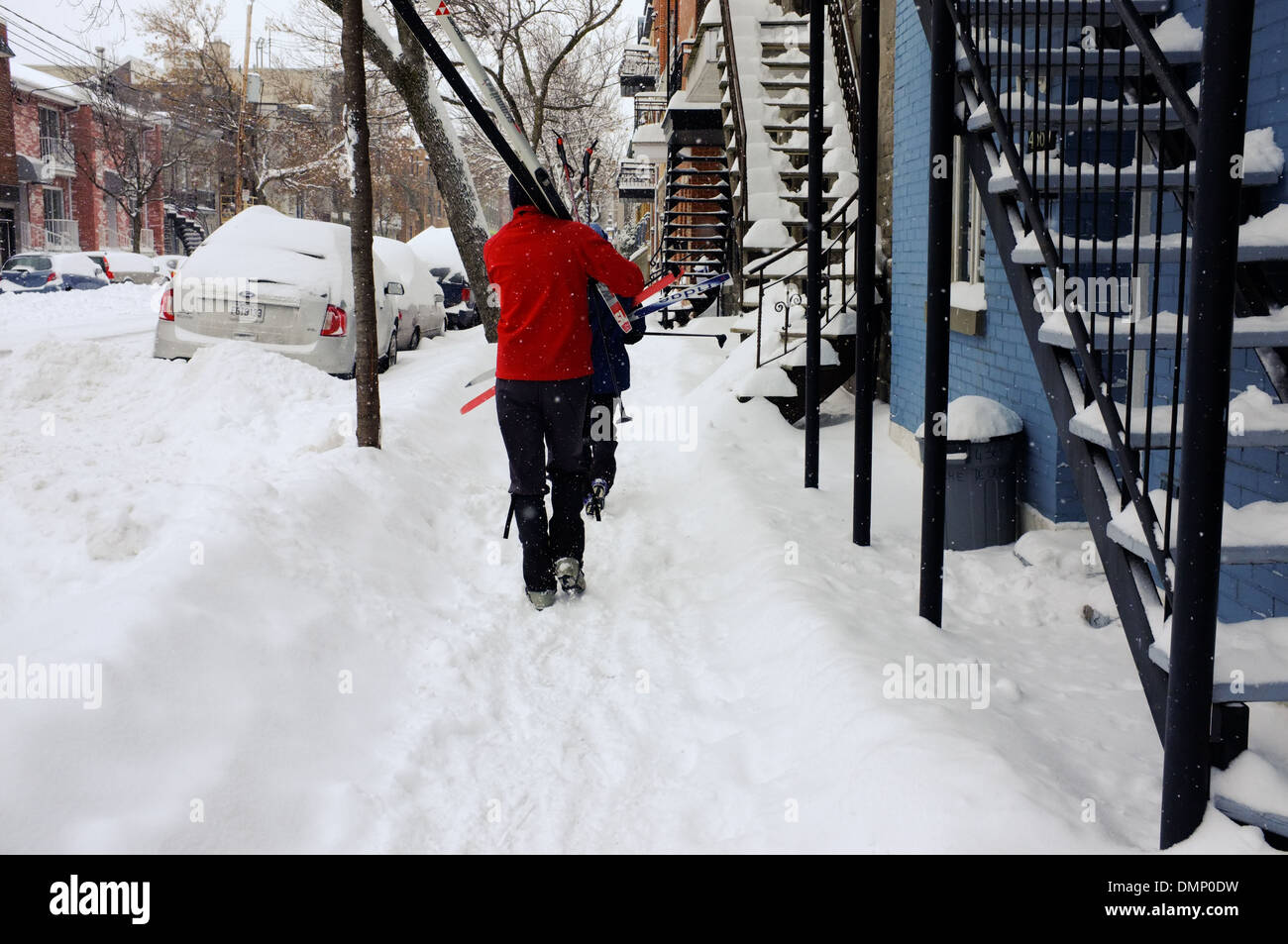 People walking through downtown Montreal with their cross country skis