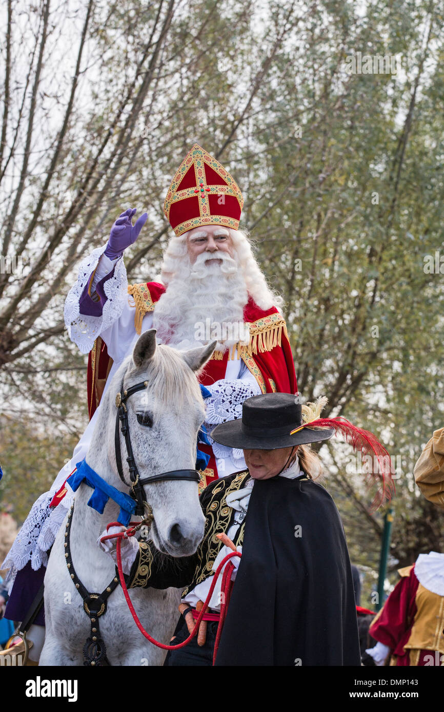 Netherlands, Kortenhoef, Saint Nicholas eve on 5 December. Saint on white horse or roan make a tour through the village Stock Photo